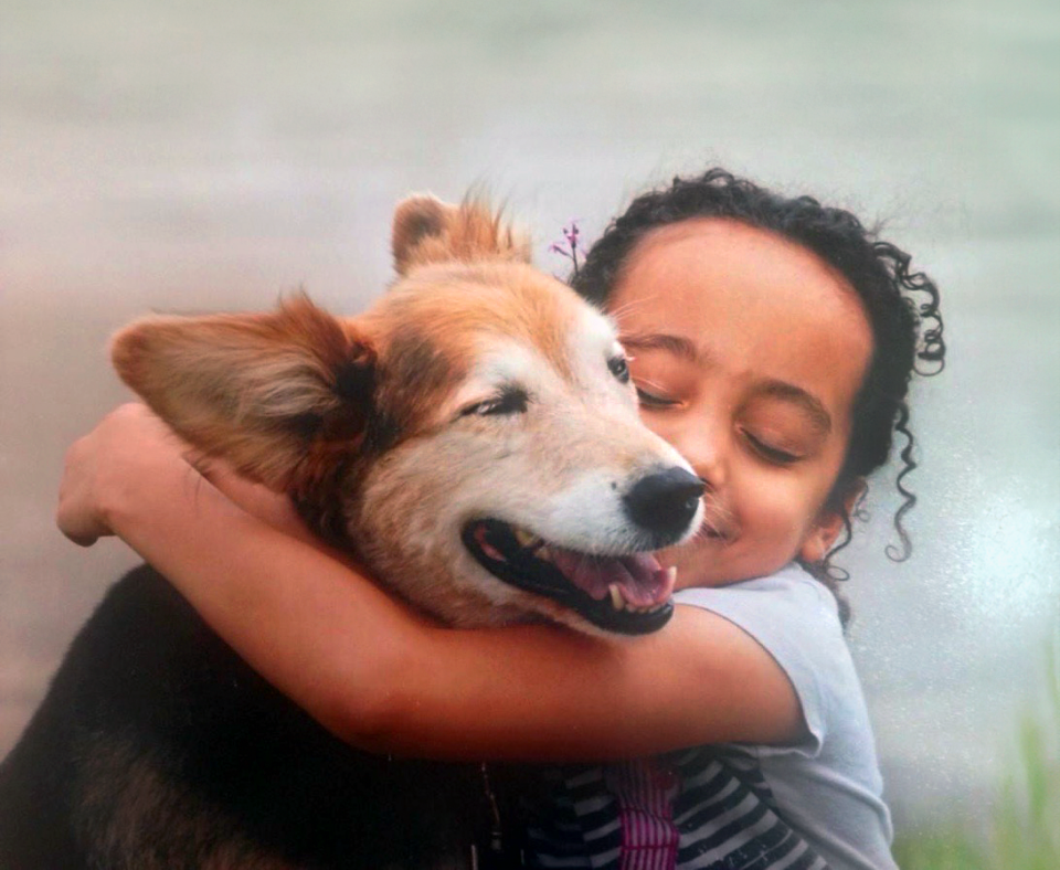 Smiling person hugging a dog