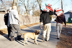 Carrying bags of pet food after Hurricane Sandy
