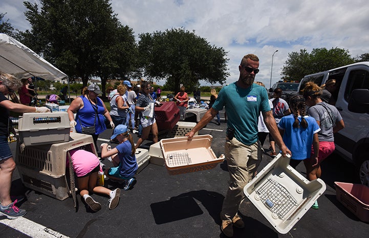 Best Friends staff member Craig Lalonde helps clean crates to be used to safely move animals from a Houston-area shelter facing evacuation