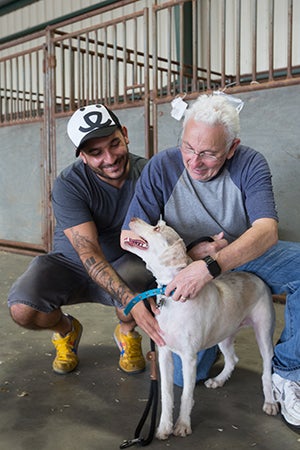 Staff member Marc Peralta visits a man with Alzheimer's who has been coming back-and-forth with his family to visit his cherished two dogs