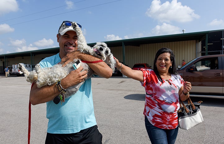 Miguel and Margarita Melendez are reunited with their dog, Precious, at the Rescue and Reunite Center