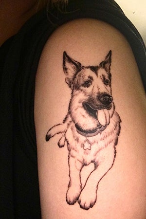 A photo of a tattoo of Harriet the German shepherd on Cheryl Chan