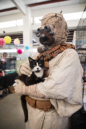 Raiser the black and white cat being held by a Boe Tusken Star Wars character at the May the 4th NKUT Super Adoption event