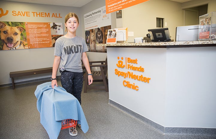 Sarah holding a humane trap for TNR
