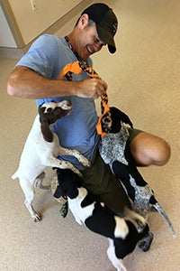 Kevin Wesely helping to socialize puppies at Best Friends Animal Sanctuary