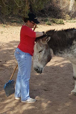 Jennifer Dujka enjoying time volunteering with Speedy the donkey