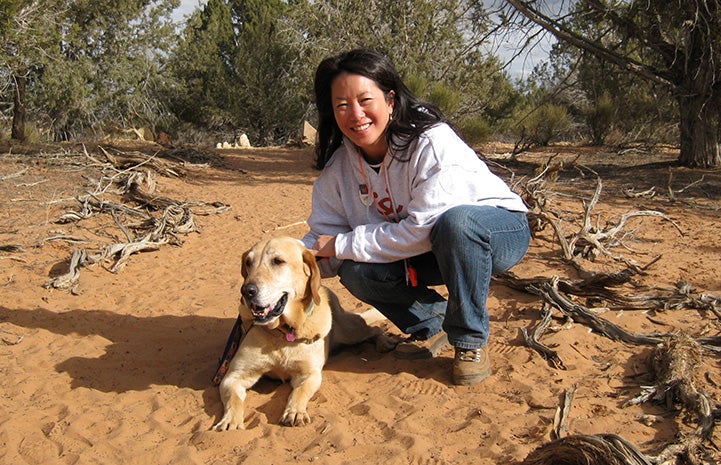 Volunteer Sophia Lim outside on a walk with a dog at Best Friends Animal Sanctuary
