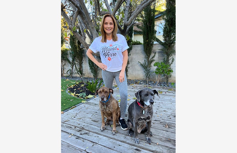 Jacqueline Piñol walking two dogs