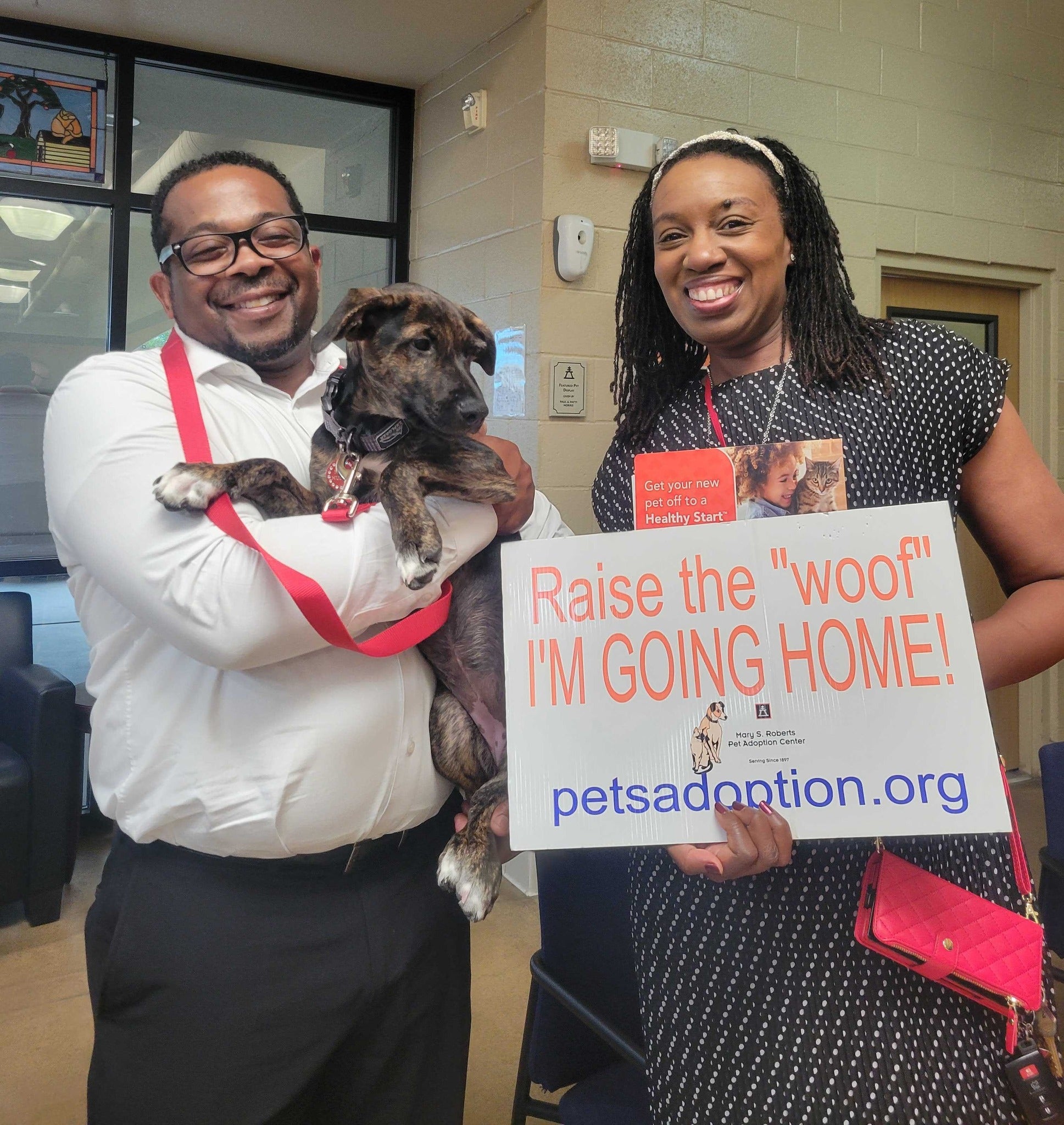 Happy couple with their newly adopted puppy from Mary S. Roberts Pet Adoption Center