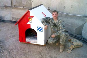 US soldier Peter kneeling next to a dog house US soldier Peter kneeling next to a dog house