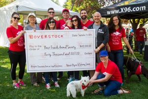 Overstock presenting a check at Strut Your Mutt