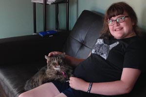 Twelve-year-old Elizabeth enjoying a sleepover with a cat