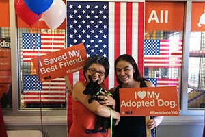 Women with their new adopted dog at the #Freedom100 promotion in Los Angeles