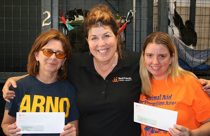 Patty Hegwood presenting checks to No More Homeless Pets Network partner groups in Louisiana