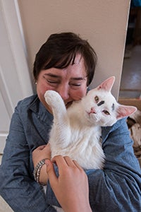Christina Zimmer snuggling with Cookie the miracle kitten