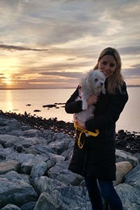 New York volunteer Kirstin Burdett with a Koch, the Maltese mix dog she fostered