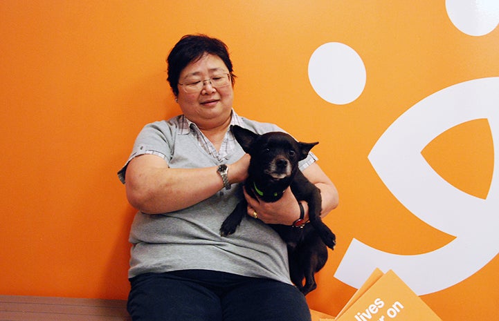 Volunteer Betty-Geargeorua with a dog at Best Friends–Atlanta