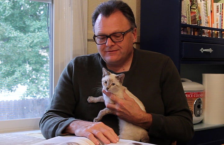 John studying with Jackie the kitten