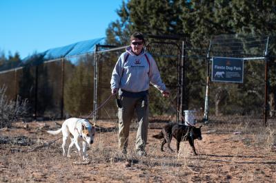 Dogtown caregiver Tom walking Elton and Hannah the dogs on their own private trail